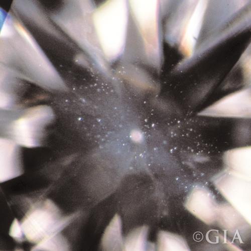 A close up of a diamond with a cloud in it.