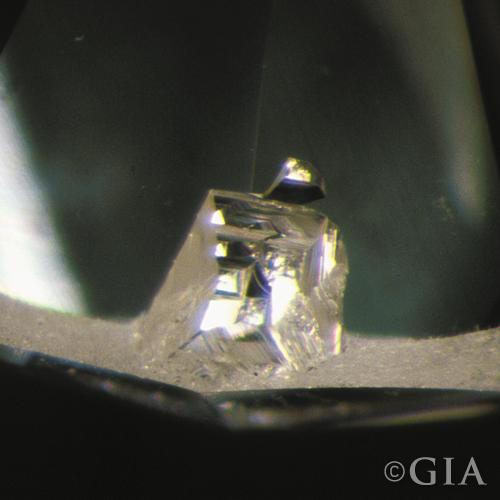A close up of a diamond with an indented natural.