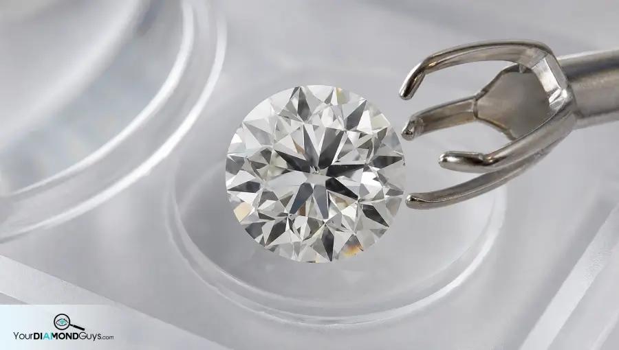 Round diamond beside a white gold prong planning tool showing safe edge inclusion placement check