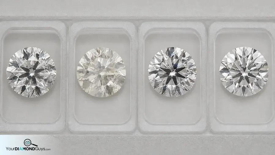 Four round diamonds in inspection lanes showing pinpoints haze mixed marks and cleaner scattered marks