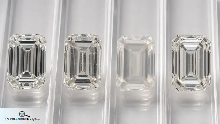 Four emerald cut diamonds showing minor graining strain lines haze and subtle review candidates