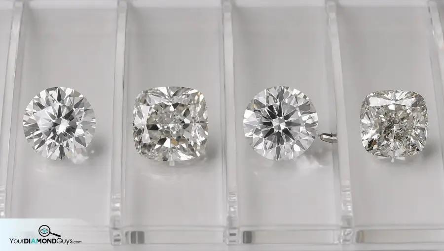 Four loose diamonds in clear inspection lanes showing small girdle natural indented natural prong contact and visible edge feature checks