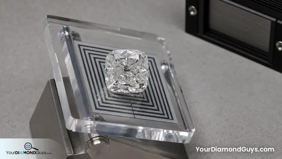 Broad table cushion diamond tilted above a sharp black and white transparency target