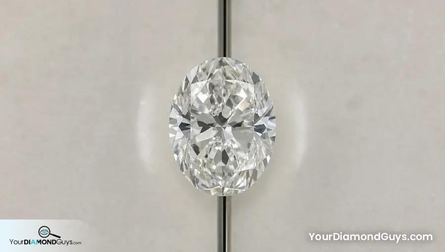 Face up oval diamond centered over a narrow mirror seam for comparing both halves