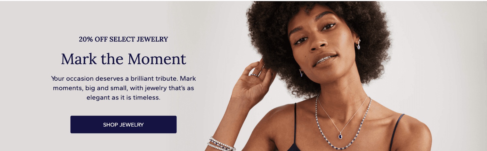 A Blue Nile ad showing a woman wearing jewerly.