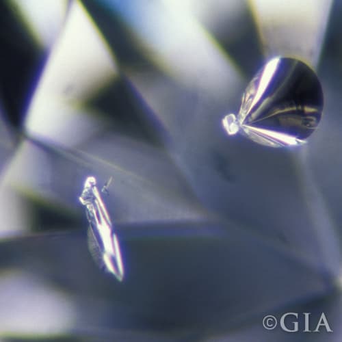 A close up of a diamond with a crystal in it.