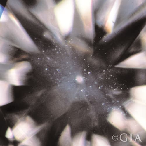 A close up of a diamond with a cloud in it.