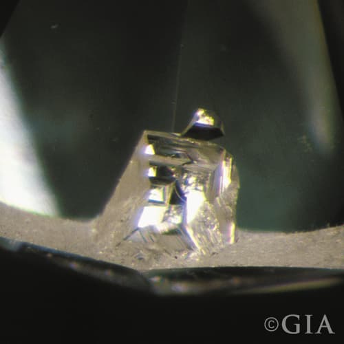 A close up of a diamond with an indented natural.