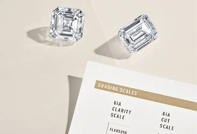 Two brilliant diamonds and the corner of a GIA report.