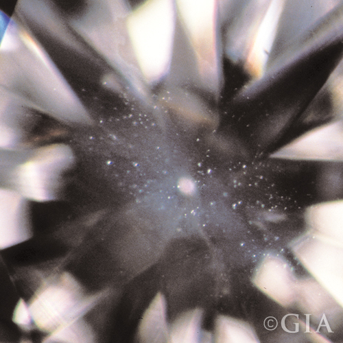 A close up of a diamond with a cloud in it.