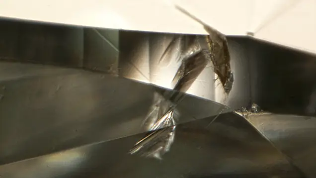 Magnified open cavity at the girdle of a diamond.