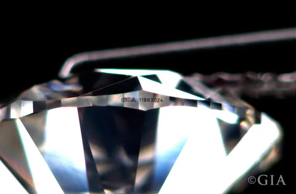 Magnified laser inscription on a diamond girdle, photographed by GIA.