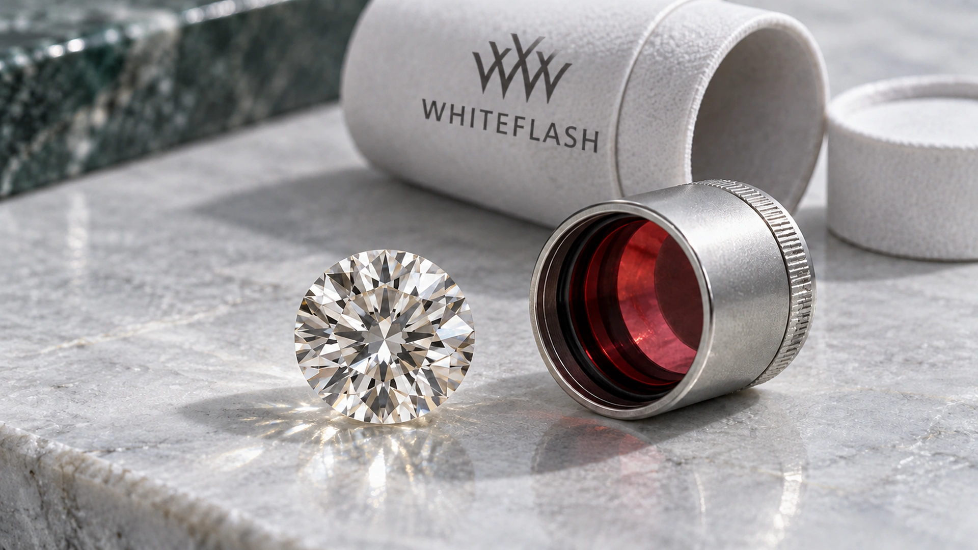 Round brilliant diamond beside a red optical viewer and a protective sleeve with the Whiteflash logo